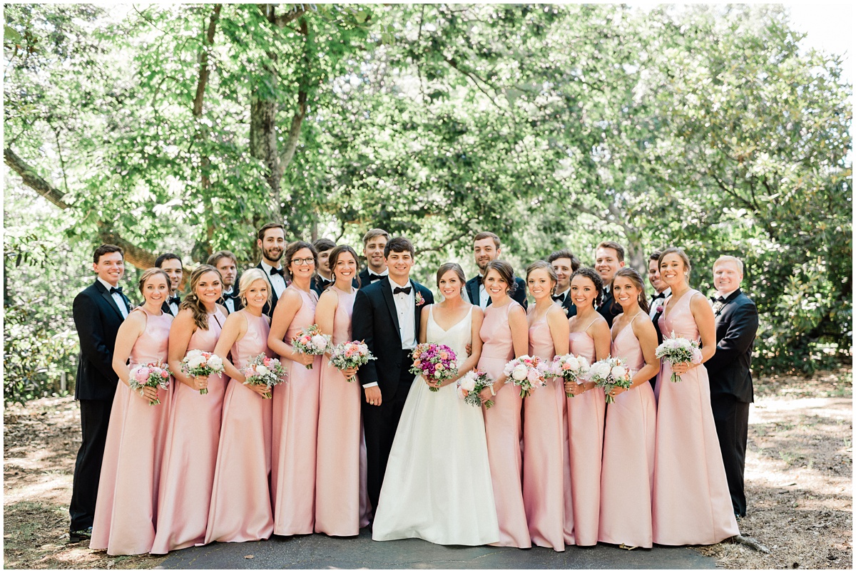 Pink bridesmaids dresses with black tuxes