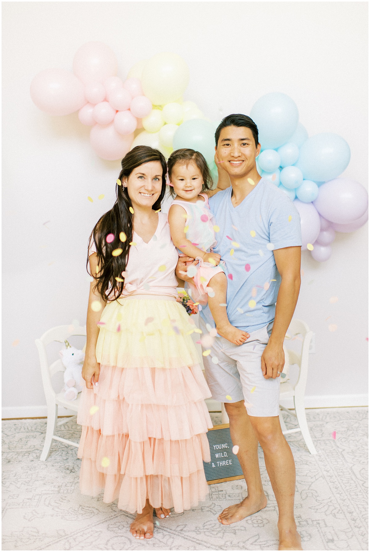 Confetti family photo for pastel rainbow birthday party