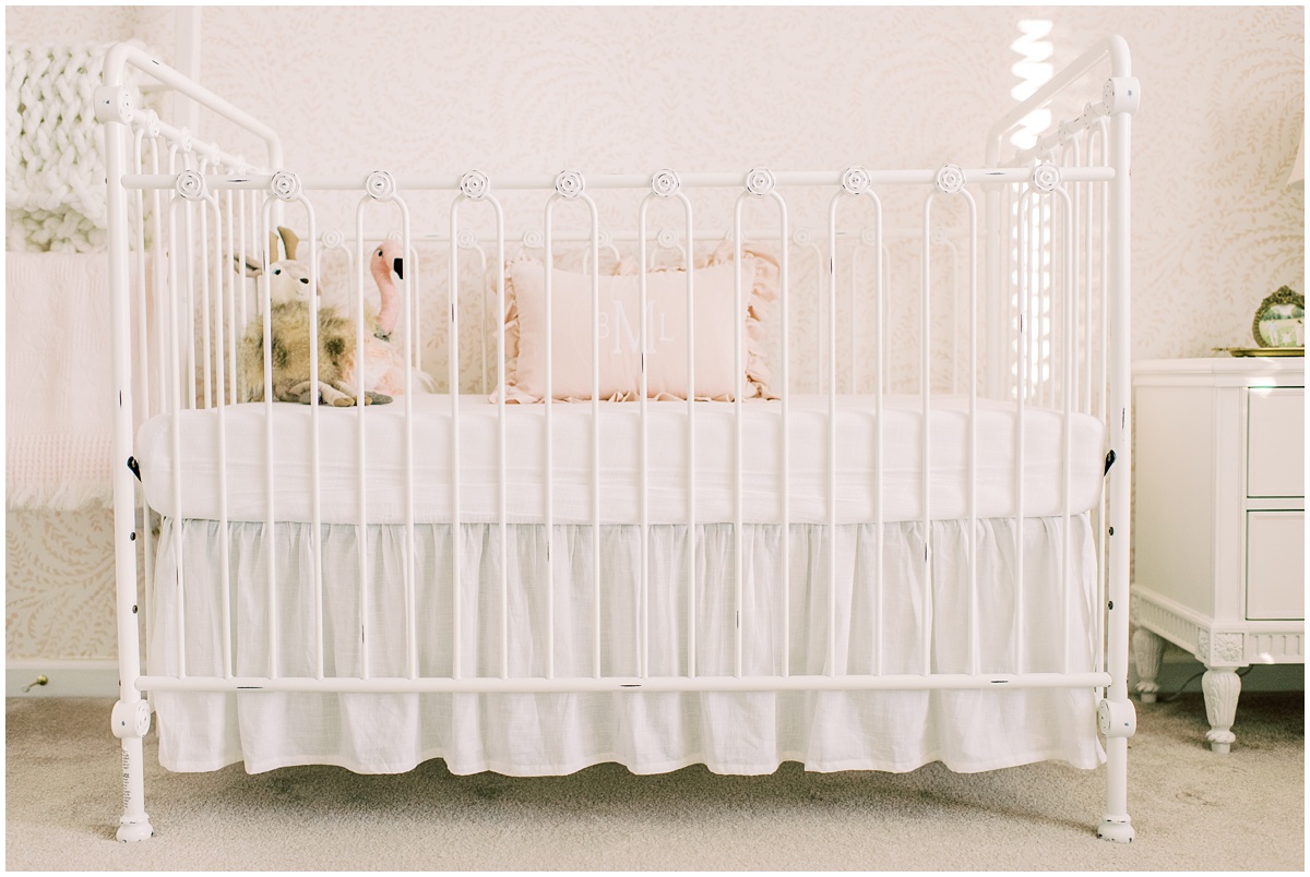White iron crib with pink details