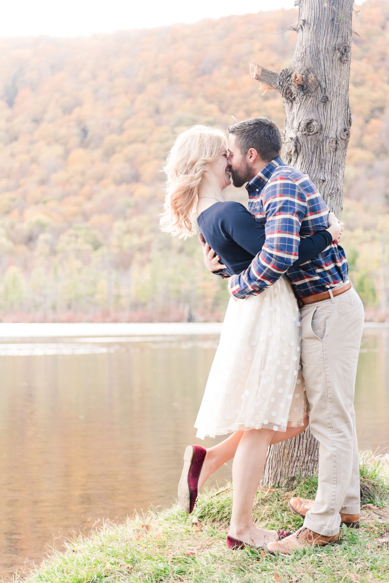 Fall Lakeside Kiss between engaged coupe Greenville, SC Wedding Photographer
